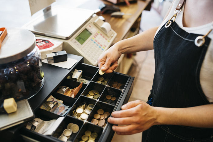 Person zählt das Geld in der Kasse